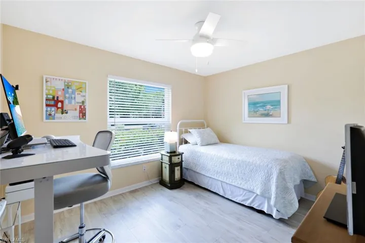 Bedroom with ceiling fan and light hardwood / wood-style floors