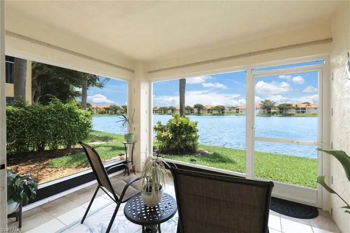 Sunroom with plenty of natural light and a water view