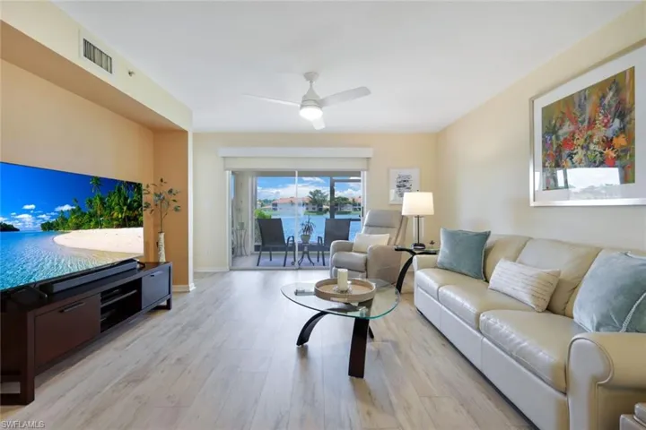 Living room featuring ceiling fan and light hardwood / wood-style floors
