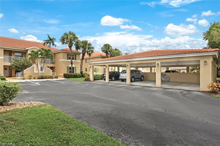 View of parking / parking lot featuring a carport