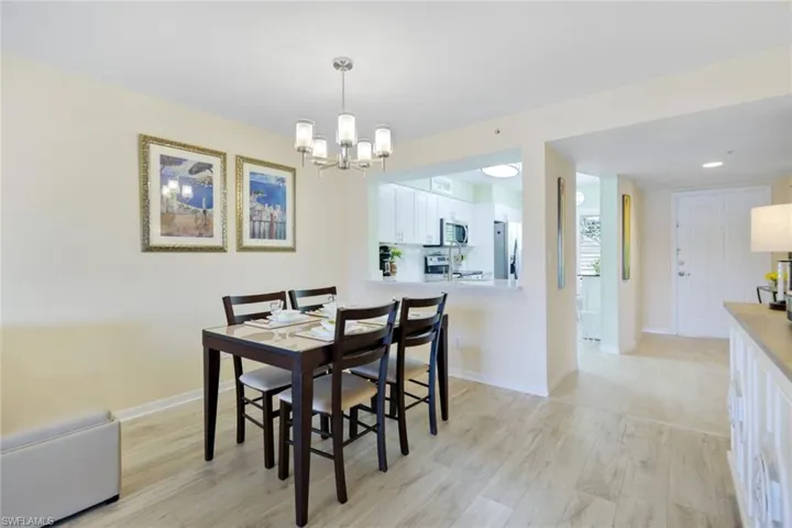 Dining room featuring light hardwood / wood-style floors and a notable chandelier