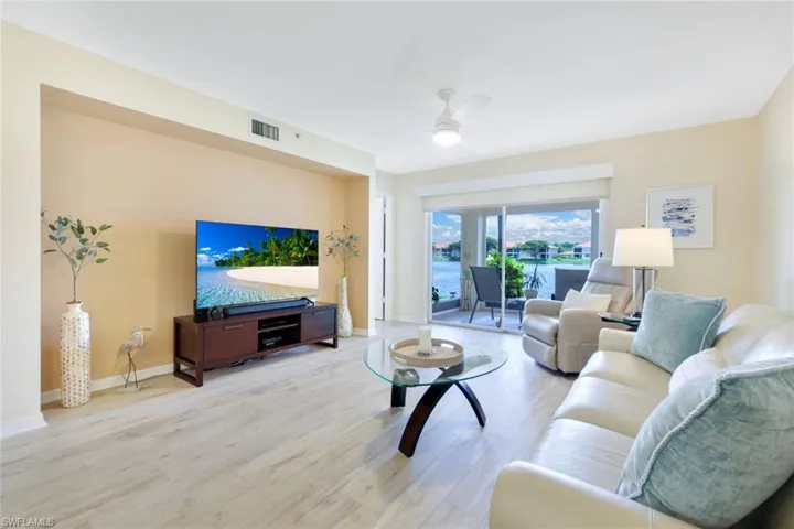 Living room featuring ceiling fan and hardwood / wood-style floors