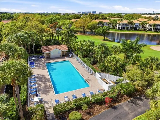 Community pool featuring a patio area, a water view, and golf course view