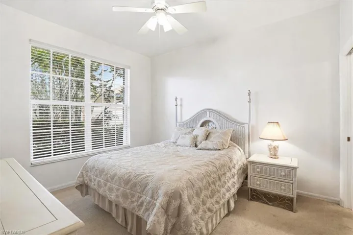 Bedroom with light carpet and ceiling fan