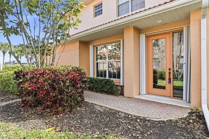 Entrance to property featuring stucco siding and a tiled roof