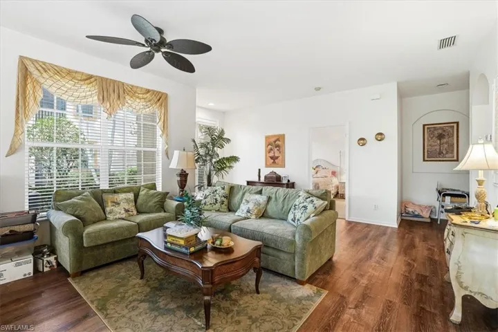 Living room with wood finished floors and ceiling fan