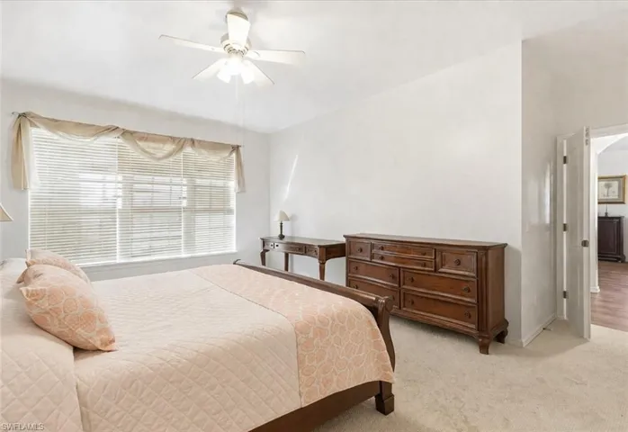 Bedroom with light carpet and ceiling fan