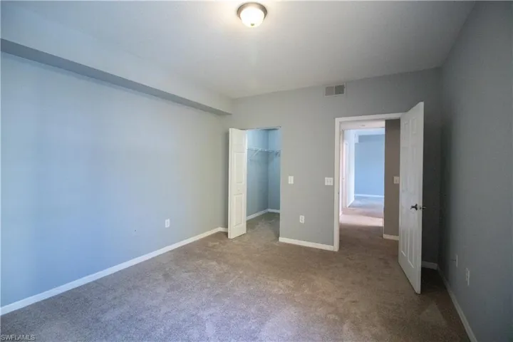 Unfurnished bedroom with carpet flooring and a closet