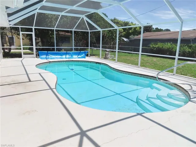 View of pool with a lawn, a lanai, and a patio