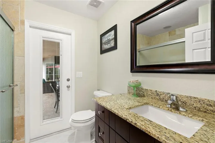 Full bathroom featuring vanity and a shower with door