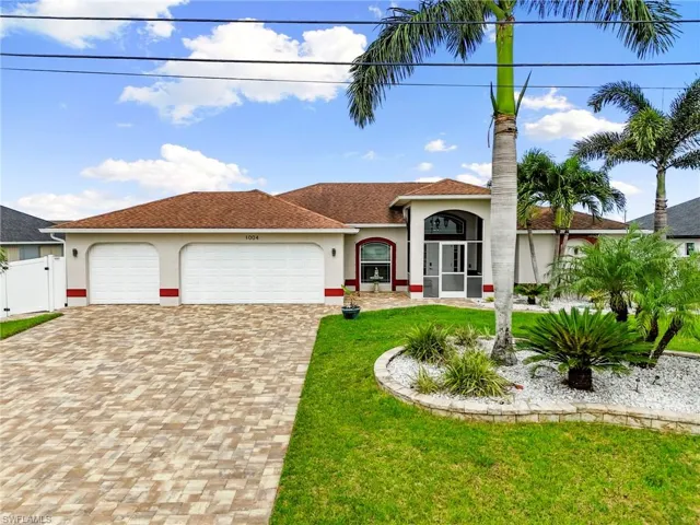 Mediterranean / spanish home featuring stucco siding, decorative driveway, a garage, a shingled roof, and a gate