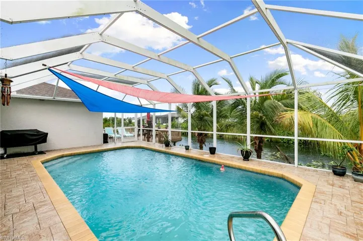 Outdoor pool with a patio and a lanai