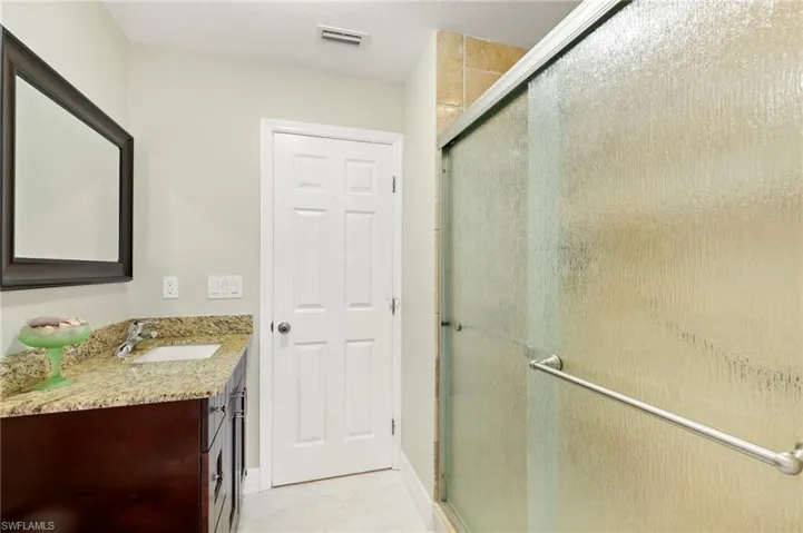 Full bath with vanity and a stall shower