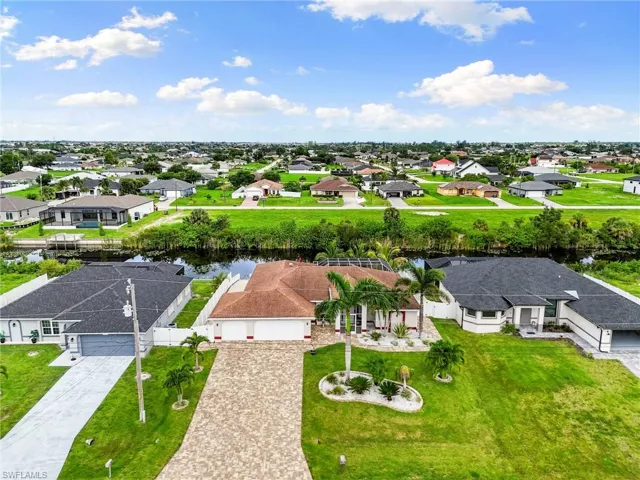 Aerial view of residential area featuring a nearby body of water