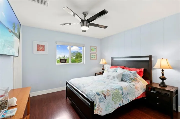 Bedroom featuring dark wood-type flooring and a ceiling fan