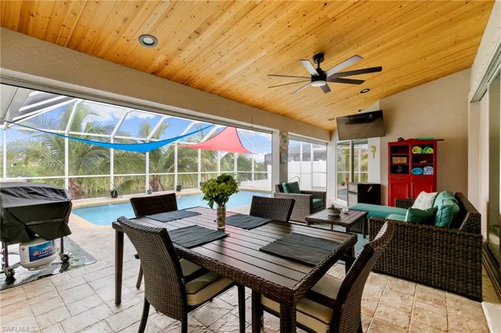View of patio with ceiling fan, an outdoor pool, an outdoor living space, and a lanai