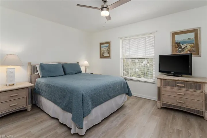 White cabinetry, newer flooring, stainless steel appliances