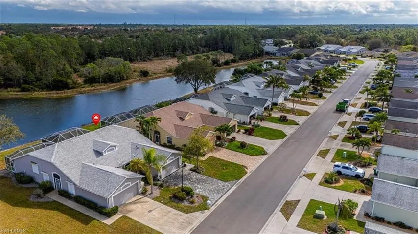 Aerial perspective of suburban area with a nearby body of water.