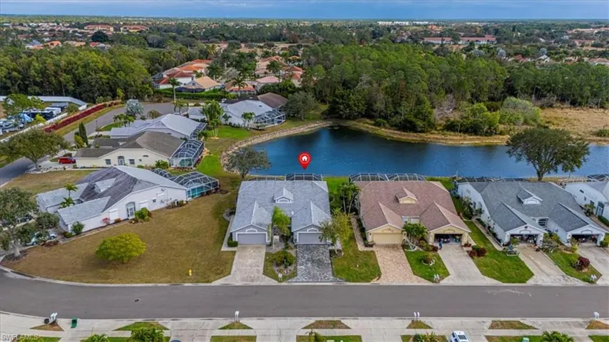 Aerial overview of property's location featuring nearby suburban area and a large body of water.