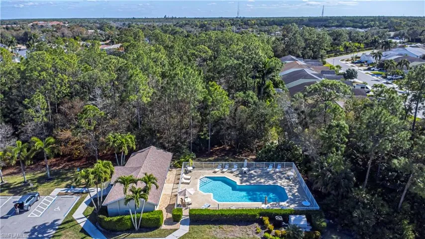 Bird's eye view of Community pool, Clubhouse & tree filled landscape.