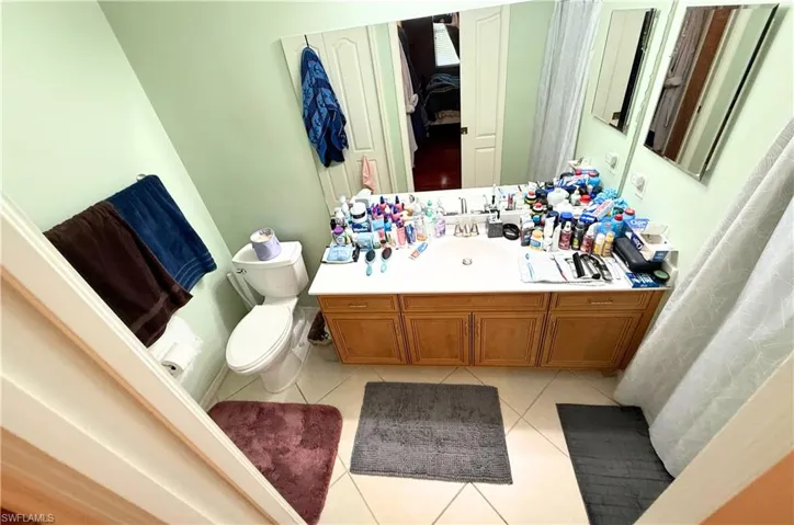 Full bath featuring tile patterned flooring and vanity