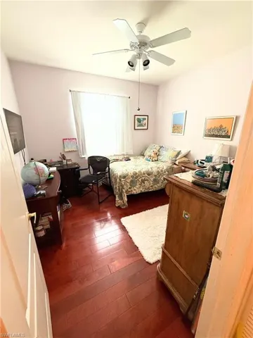 Bedroom featuring dark wood finished floors and a ceiling fan