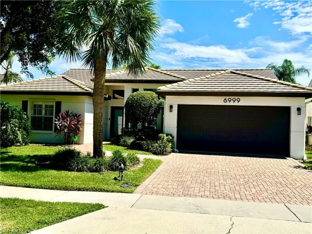 Ranch-style home with a front yard and a garage