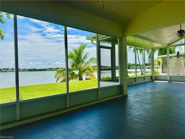 Patio/sunroom with a water view and ceiling fan