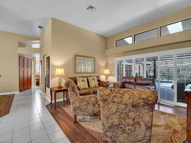 Living room featuring high vaulted ceiling and light hardwood / wood-style floors