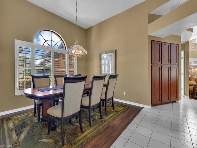 Dining room featuring an inviting chandelier, light tile patterned floors, and a healthy amount of sunlight