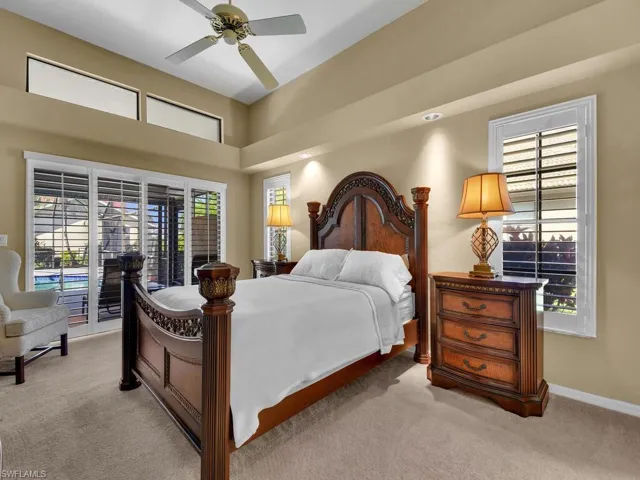 Bedroom with access to outside, light colored carpet, and ceiling fan