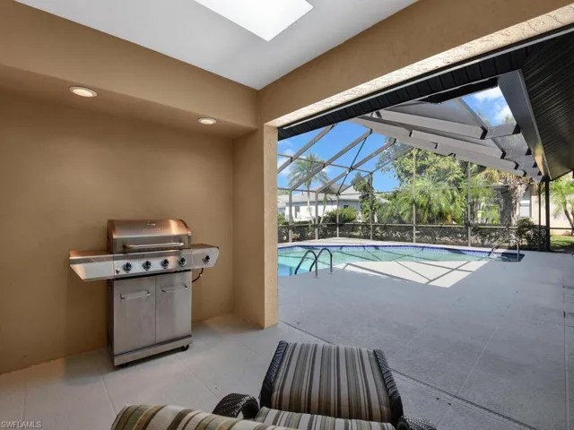 View of swimming pool with a grill, a lanai, and a patio area