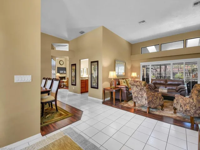 Living room with a towering ceiling and light tile patterned floors