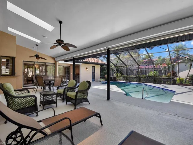 View of pool featuring a lanai, a patio area, and ceiling fan