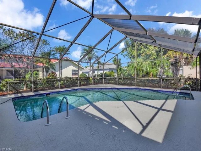 View of pool featuring glass enclosure