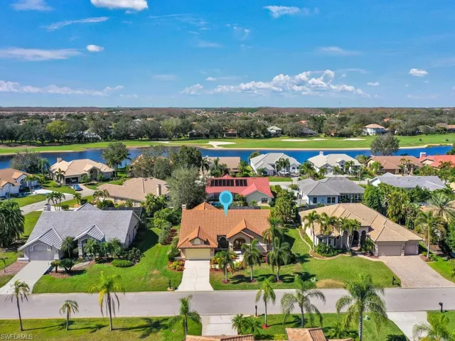 Birds eye view of property with a water view