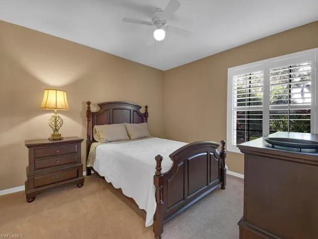 Bedroom featuring light colored carpet and ceiling fan