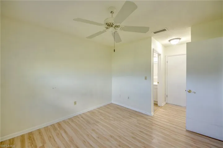 Empty room featuring light wood-type flooring and ceiling fan