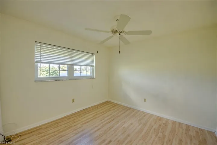Spare room featuring ceiling fan and light wood-type flooring