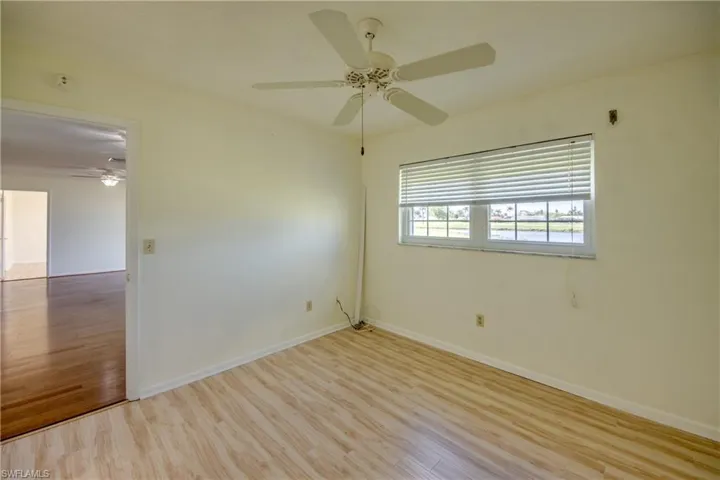 Unfurnished room with light hardwood / wood-style flooring and ceiling fan