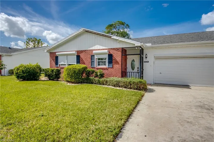 Ranch-style home with a garage and a front yard