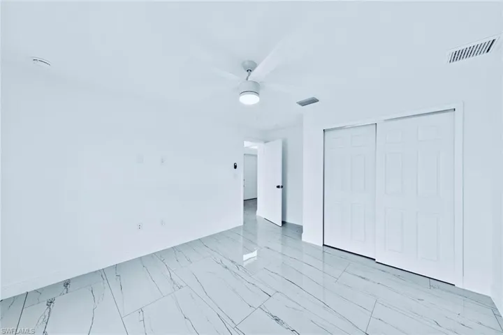Unfurnished bedroom with a closet and ceiling fan