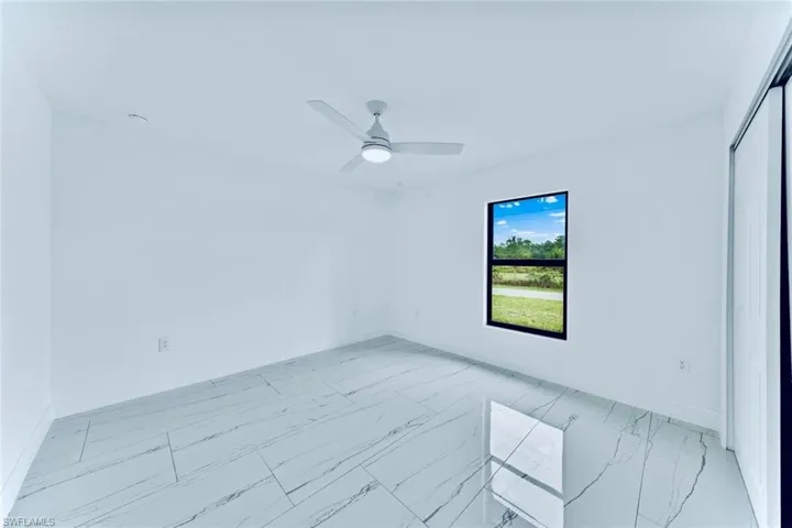 Spare room with ceiling fan