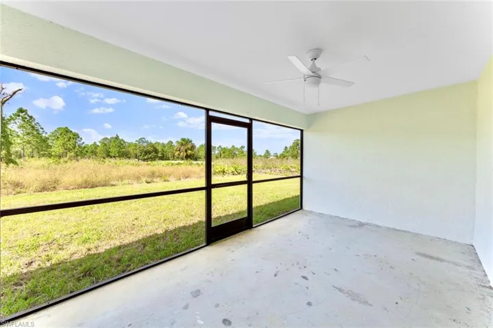 Unfurnished sunroom featuring ceiling fan