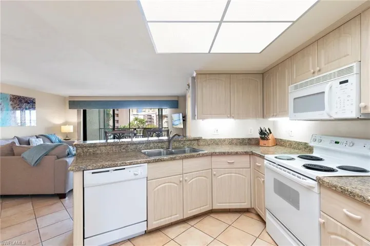 Kitchen has counter with bar stools