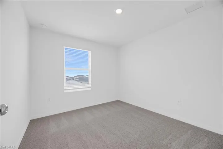 Neutral-toned carpeting paired with crisp white walls