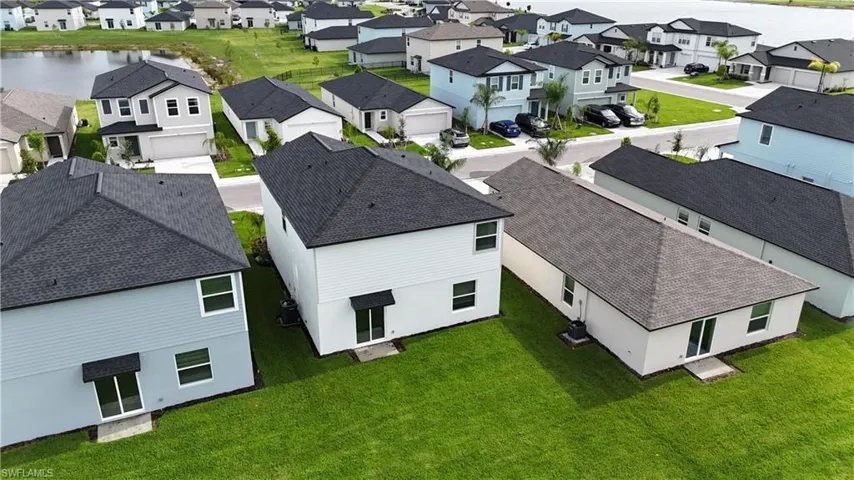 Expansive residential development featuring multiple single-family homes with dark shingle roofs