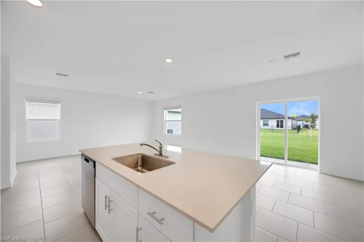 Kitchen island with an undermount sink and stainless steel faucet