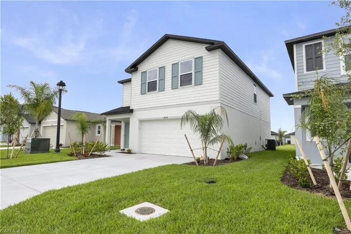 Contemporary two-story residence featuring white siding and contrasting dark trim