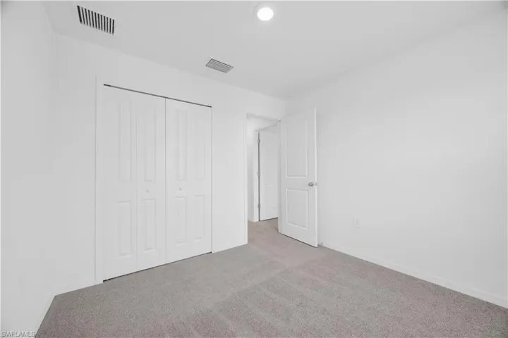 Neutral-toned carpeting complements bright white walls and trim
